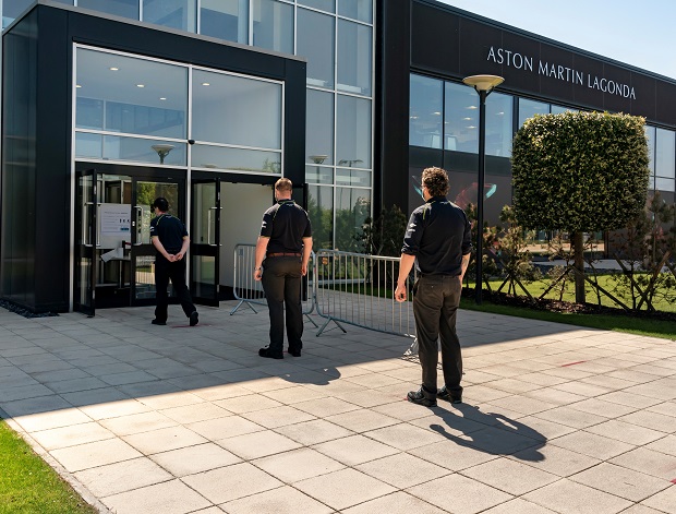 Aston Martin employees in a socially distanced queue outside the building
