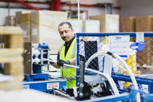 CHH employee working with machine